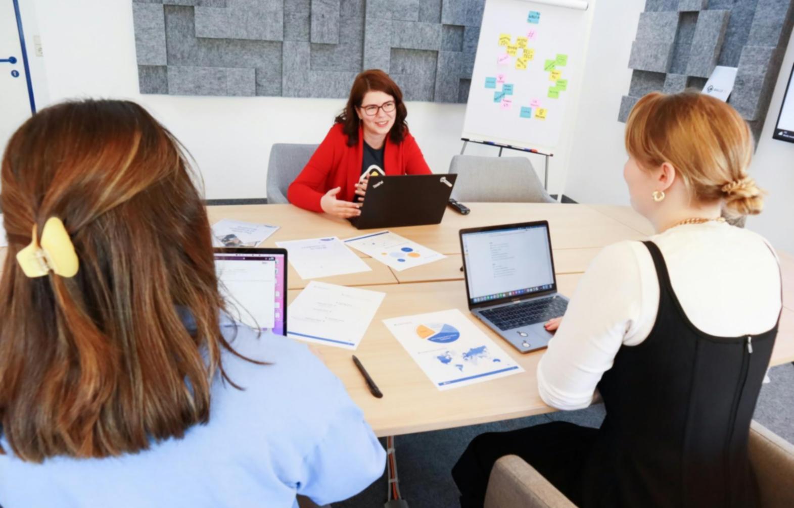 Business professionals collaborating on financial planning documents in modern office setting